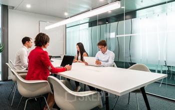 Professionals collaborating in a modern, well-lit conference room at the prime office space rental located at Richtistrasse 7, Zürich East.